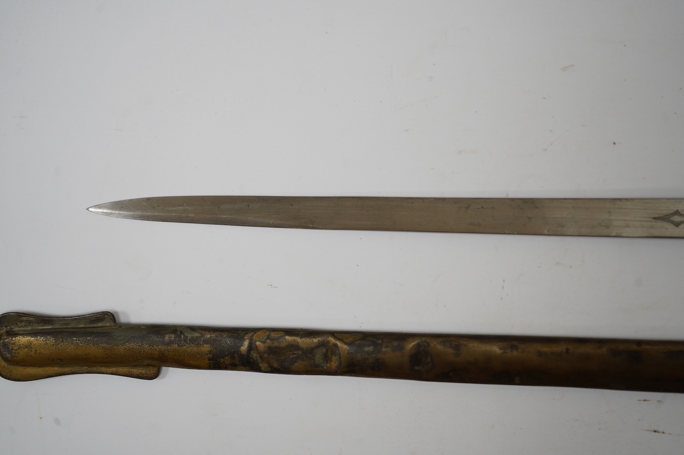 An Edward VII 1897 pattern infantry officer’s sword by Wilkinson, number 40202, blade etched with regulation designs and owners initials; KDA, regulation guard in its steel scabbard. Condition - fair, scabbard badly dent